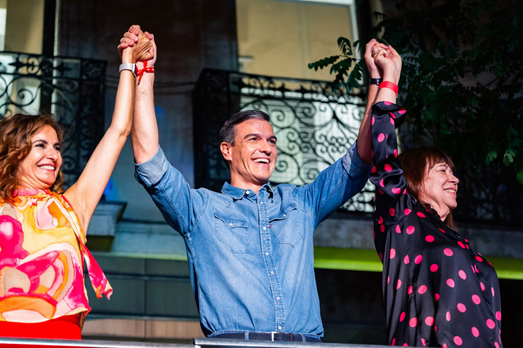 MADRID, SPAIN - 2023/07/23: Pedro Sanchez (C) and Maria Jesus Montero (L), Spanish minister of finance, with Cristina Narbona (R), president of PSOE, party celebrate the good results achieved on the election night of 23 July 2023 in the street with the crowd in front of the national headquarters of the PSOE party in Madrid. (Photo by Alberto Gardin/SOPA Images/LightRocket via Getty Images)
