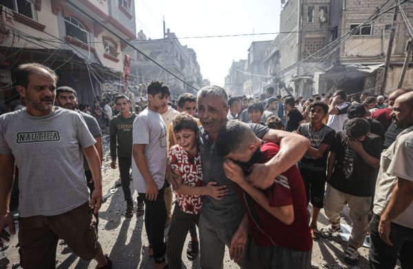 KHAN YUNIS, GAZA - OCTOBER 24: People get upset near a heavily damaged building after Israeli attacks by warplanes and artillery fire as civil defense teams and civilians conduct search and rescue operations in Khan Yunis, Gaza on October 24, 2023. (Photo by Mustafa Hassona/Anadolu via Getty Images)